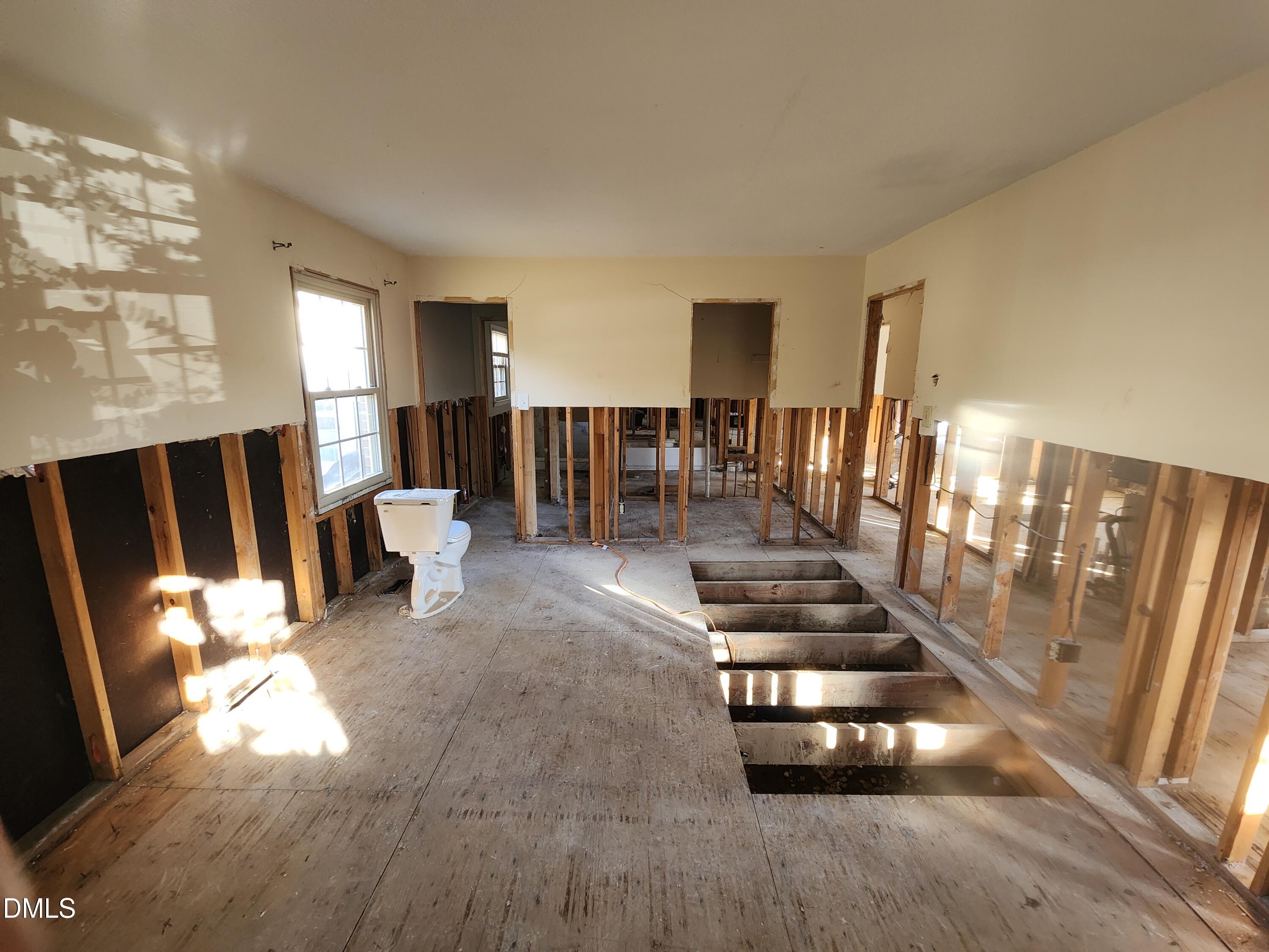 309 Rippling Stream Road Durham, NC 27704 - Photo 20 of 36 a view of a livingroom with wooden floor and stairs