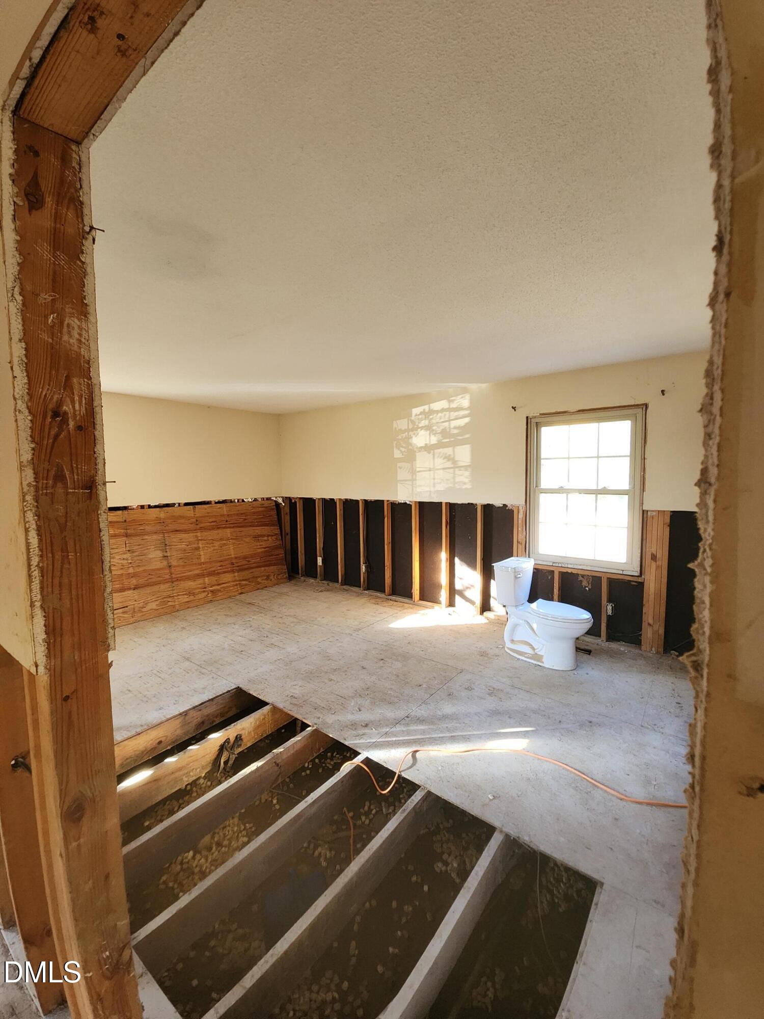309 Rippling Stream Road Durham, NC 27704 - Photo 21 of 36 a view of a living room with furniture and a fireplace