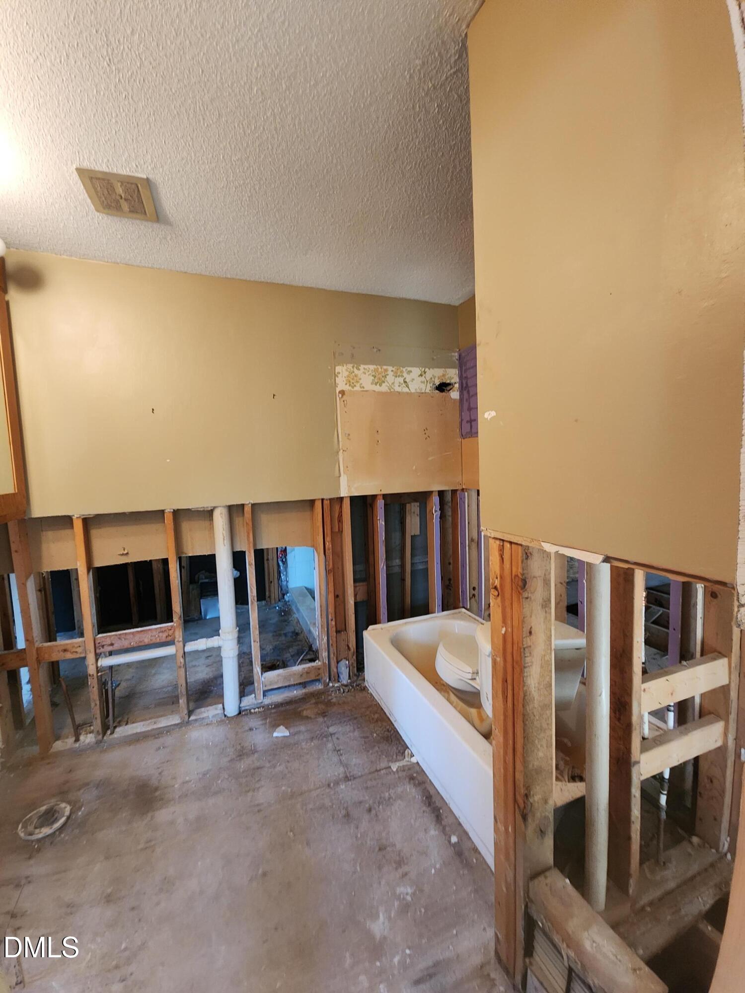 309 Rippling Stream Road Durham, NC 27704 - Photo 22 of 36 a bed room with a bed and glass door