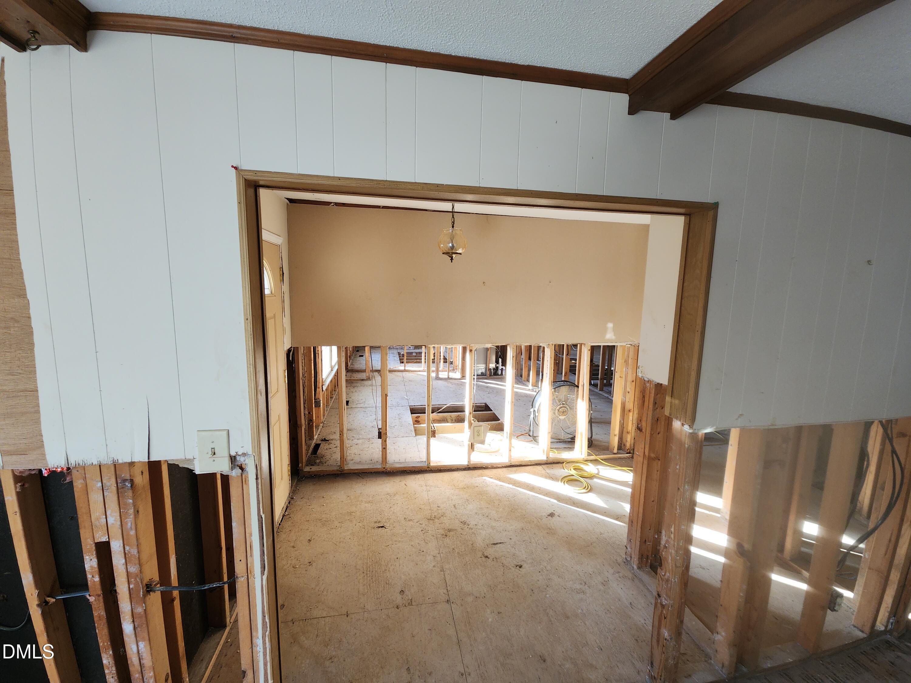 309 Rippling Stream Road Durham, NC 27704 - Photo 24 of 36 a view of an empty room with wooden floor and a window