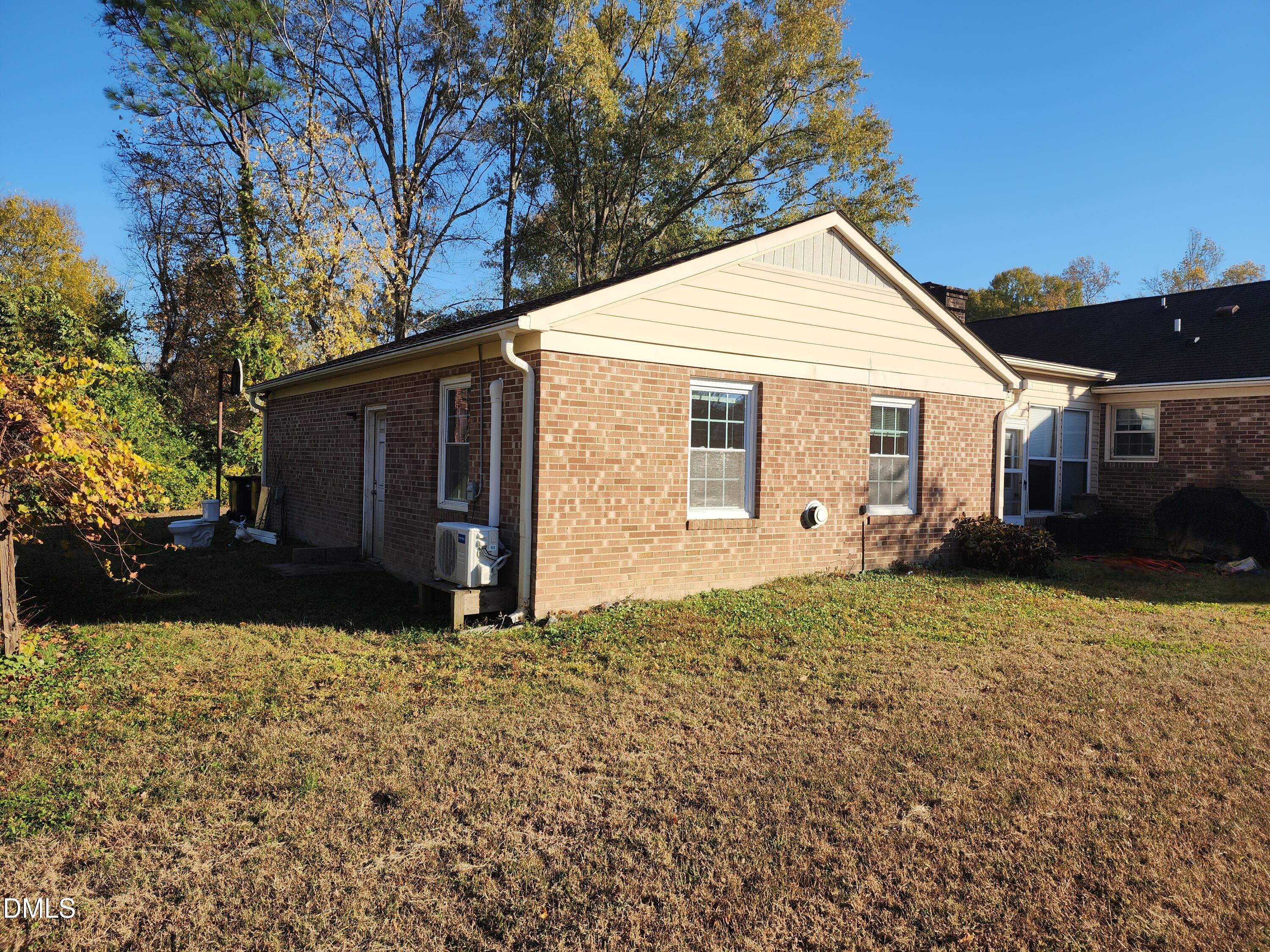 309 Rippling Stream Road Durham, NC 27704 - Photo 3 of 36 a view of a house with a yard