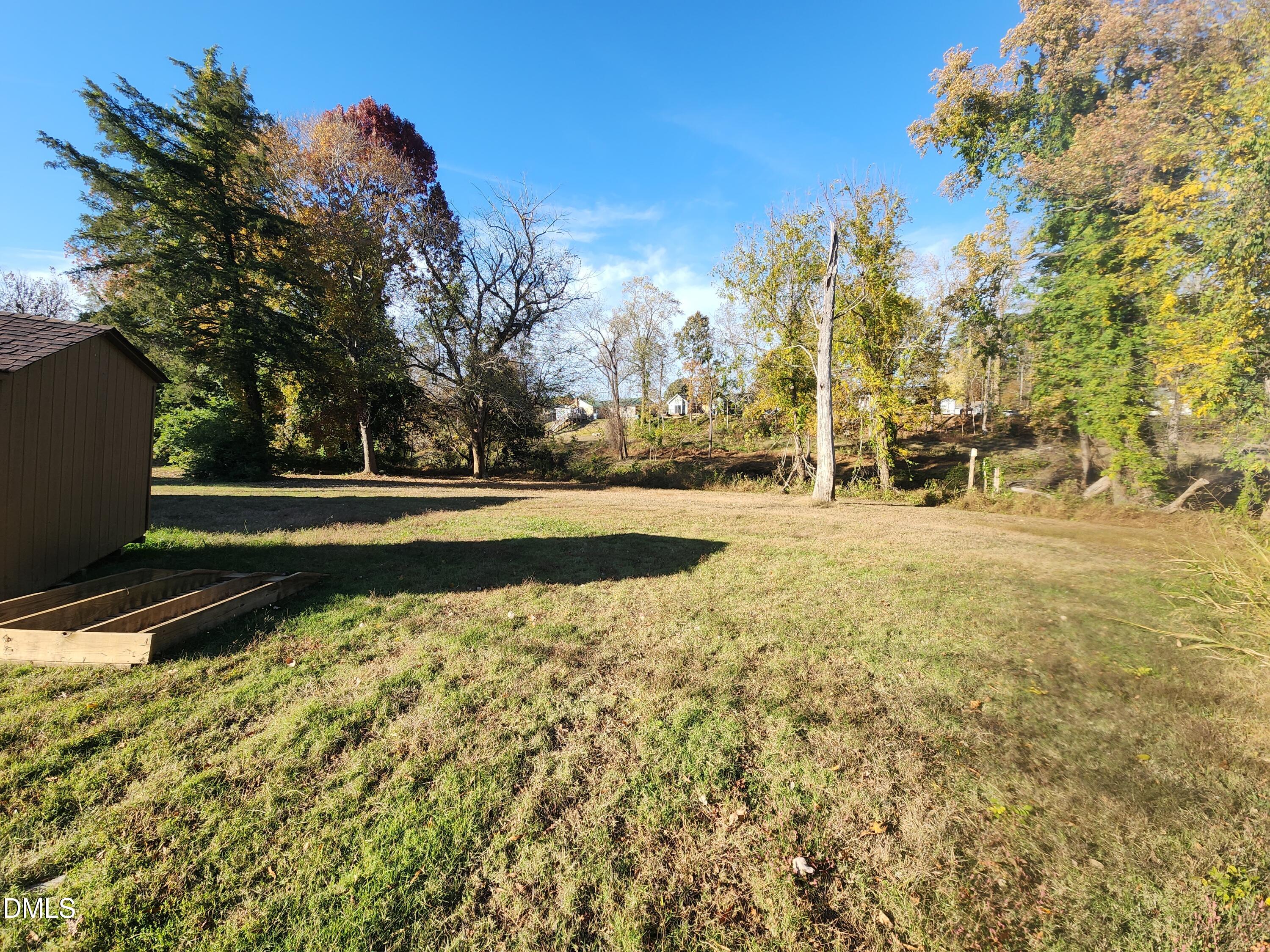 309 Rippling Stream Road Durham, NC 27704 - Photo 5 of 36 a view of a yard with large trees