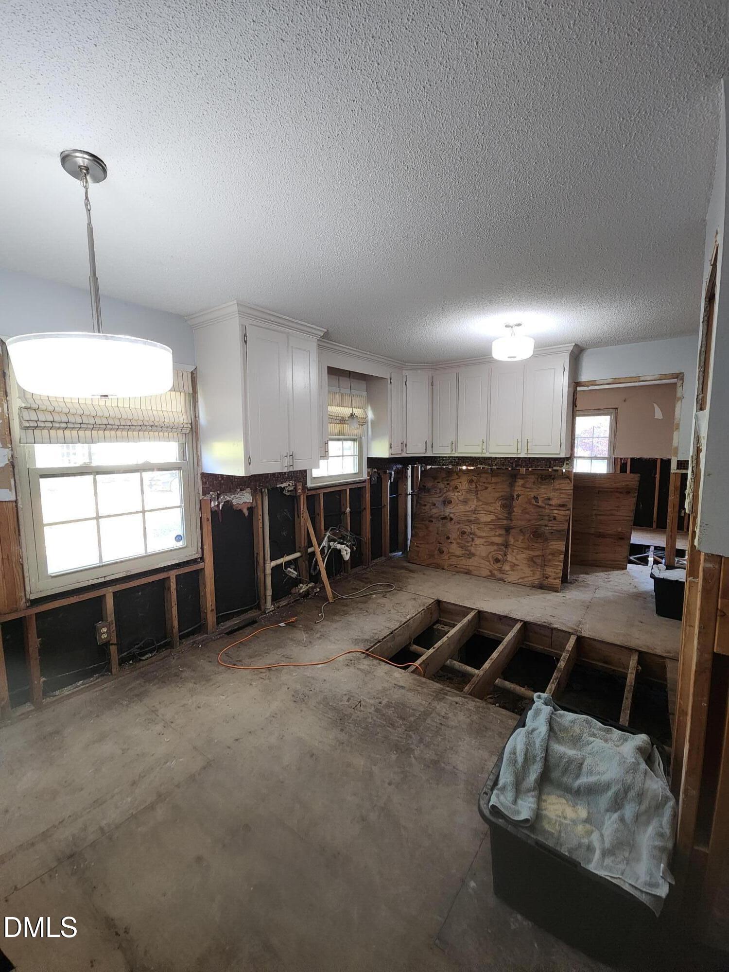 309 Rippling Stream Road Durham, NC 27704 - Photo 7 of 36 a kitchen with furniture and a counter top space