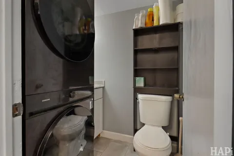 a bathroom with a toilet and a mirror