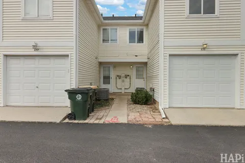 a view of a house with a patio and a yard