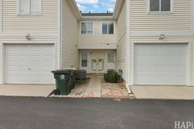 a view of a house with a patio and a yard