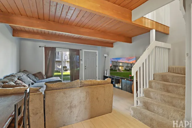 a living room with furniture fireplace and a potted plant