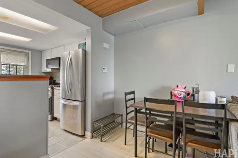 a view of a kitchen with refrigerator and breakfast area