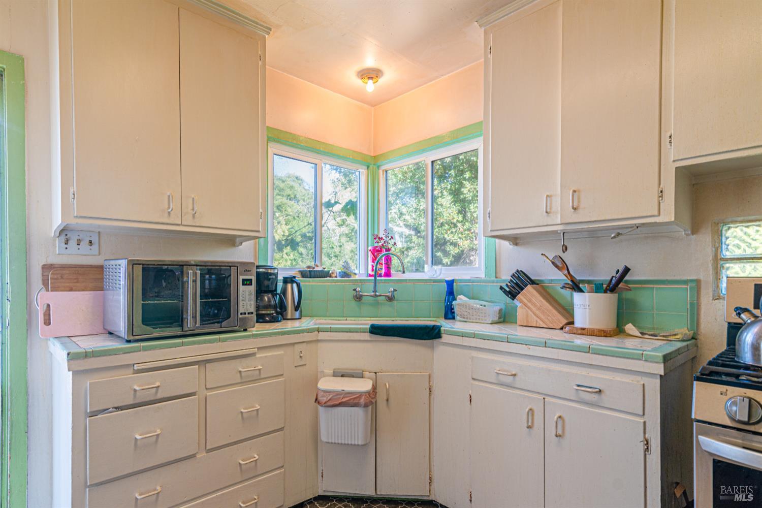 1852 4th Street Santa Rosa, CA 95404 - Photo 14 of 39 a kitchen with white cabinets and window