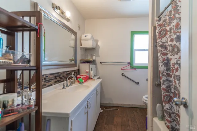 a bathroom with a sink toilet and shower