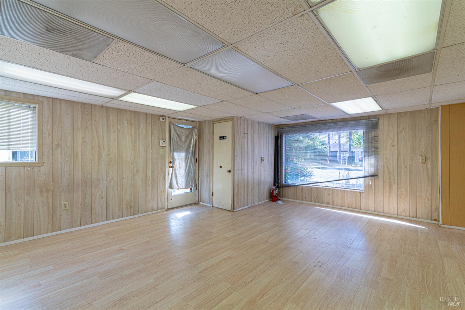 1852 4th Street Santa Rosa, CA 95404 - Photo 28 of 39 a view of an empty room with wooden floor and a window