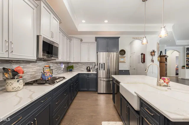 a kitchen with a sink dishwasher a refrigerator and cabinets
