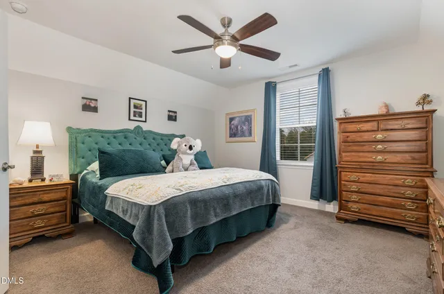 a bedroom with a bed and a ceiling fan
