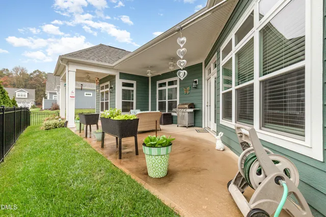 a view of a patio with chairs and potted plants