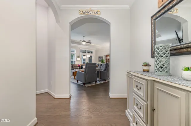 a view of living room with furniture and a mirror