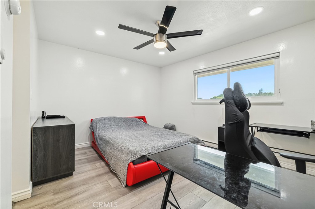 1349 Edgewood Way, Unit 49 Oxnard, CA 93030 - Photo 12 of 32 a bedroom with bed and a chandelier