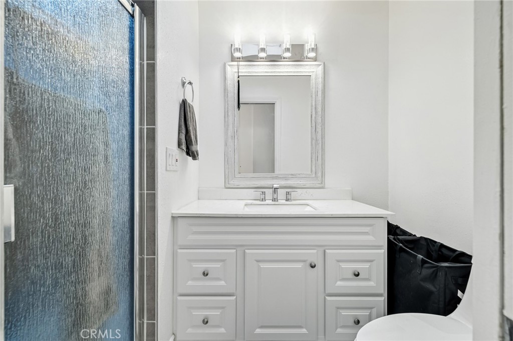 1349 Edgewood Way, Unit 49 Oxnard, CA 93030 - Photo 14 of 32 a bathroom with a granite countertop sink and a mirror