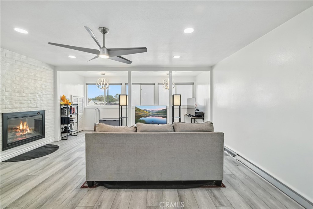 1349 Edgewood Way, Unit 49 Oxnard, CA 93030 - Photo 3 of 32 a living room with furniture and a fireplace