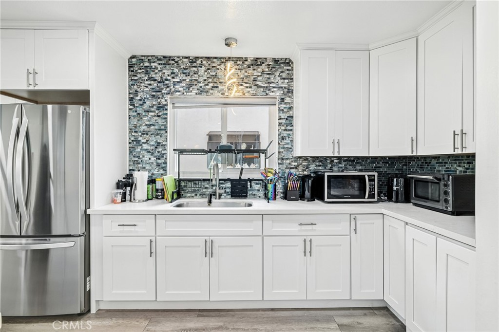 1349 Edgewood Way, Unit 49 Oxnard, CA 93030 - Photo 6 of 32 a kitchen with white cabinets and refrigerator