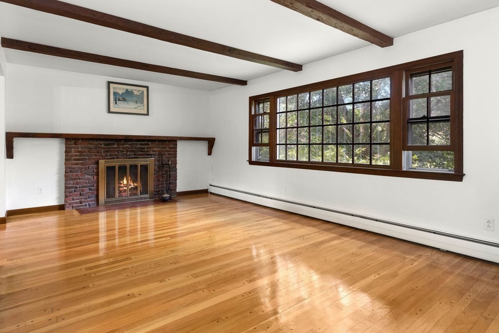 15 Silverbrook Road Topsfield, MA 01983 - Photo 3 of 42 a view of an empty room with a fireplace and a window
