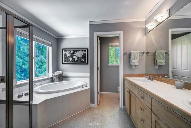 a bathroom with a sink double vanity and a shower