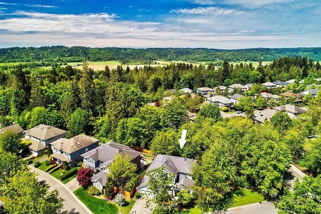 a view of a house with a yard and potted plants