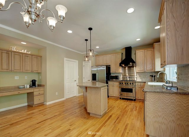 a kitchen with refrigerator and cabinets