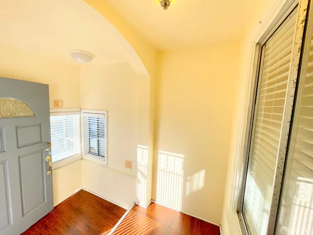 a view of a living room with a furniture and floor to ceiling window