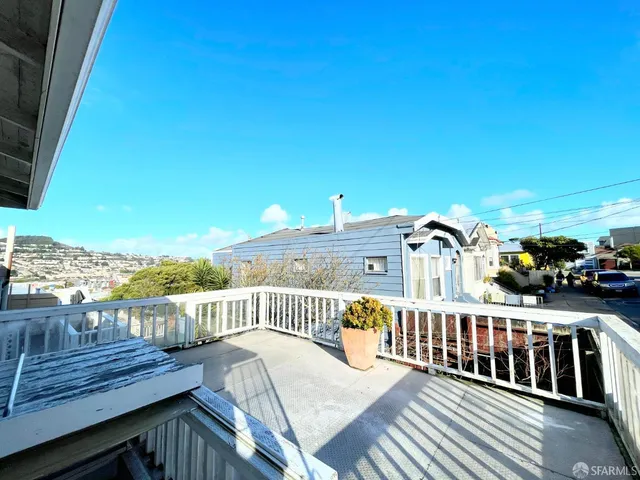 a view of a roof deck with wooden fence