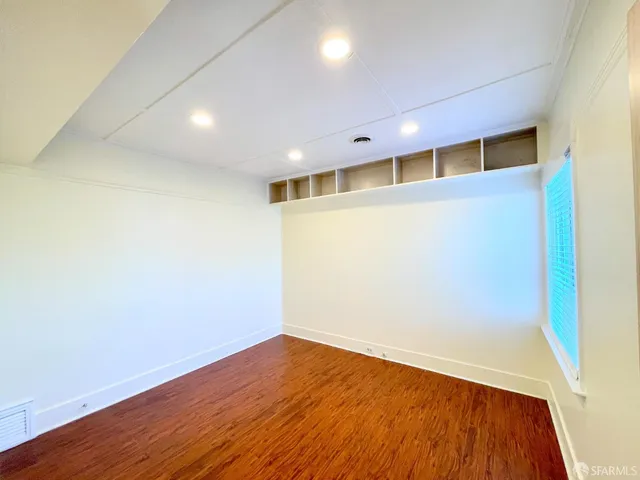 an empty room with wooden floor