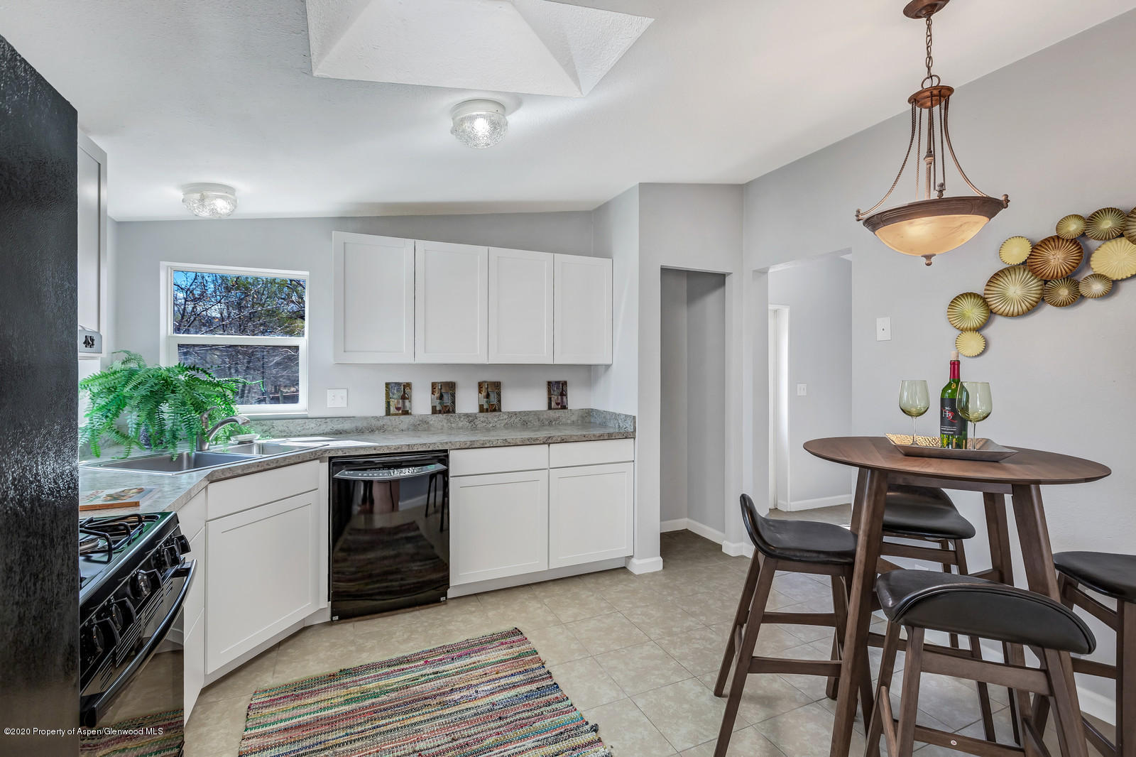 353 West 5th Street Rifle, CO 81650 - Photo 3 of 11 a kitchen with stainless steel appliances granite countertop a stove and a refrigerator