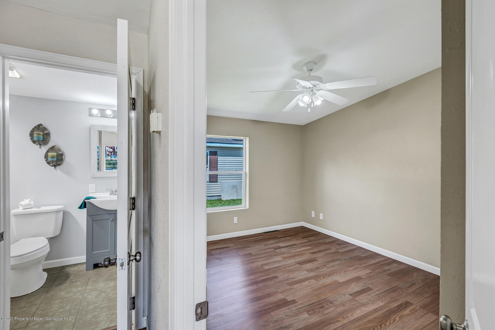 353 West 5th Street Rifle, CO 81650 - Photo 5 of 11 a view of a room with wooden floor and a ceiling fan