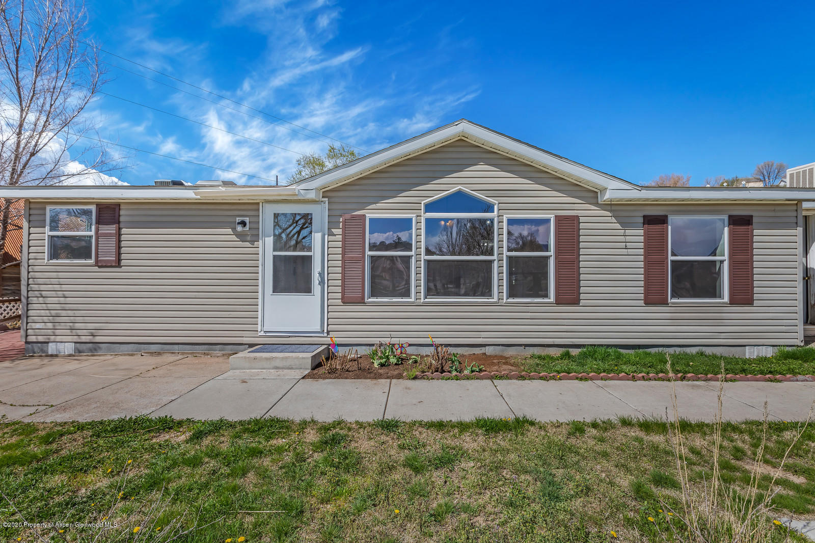 353 West 5th Street Rifle, CO 81650 - Photo 8 of 11 a front view of a house with a yard