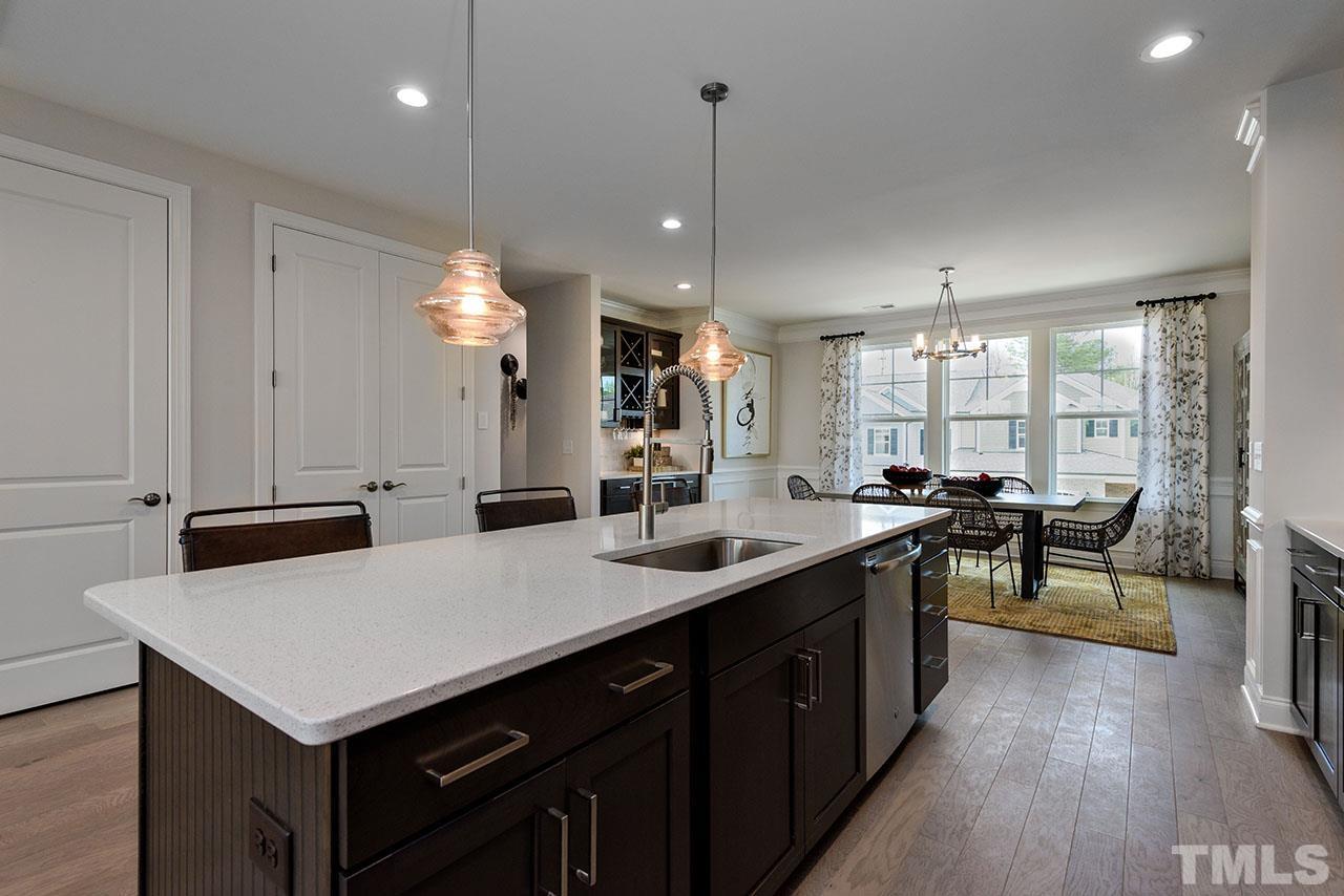 6946 Leesville Road, Unit 13 Raleigh, NC 27613 - Photo 22 of 30 a kitchen with a sink a counter top space and stainless steel appliances
