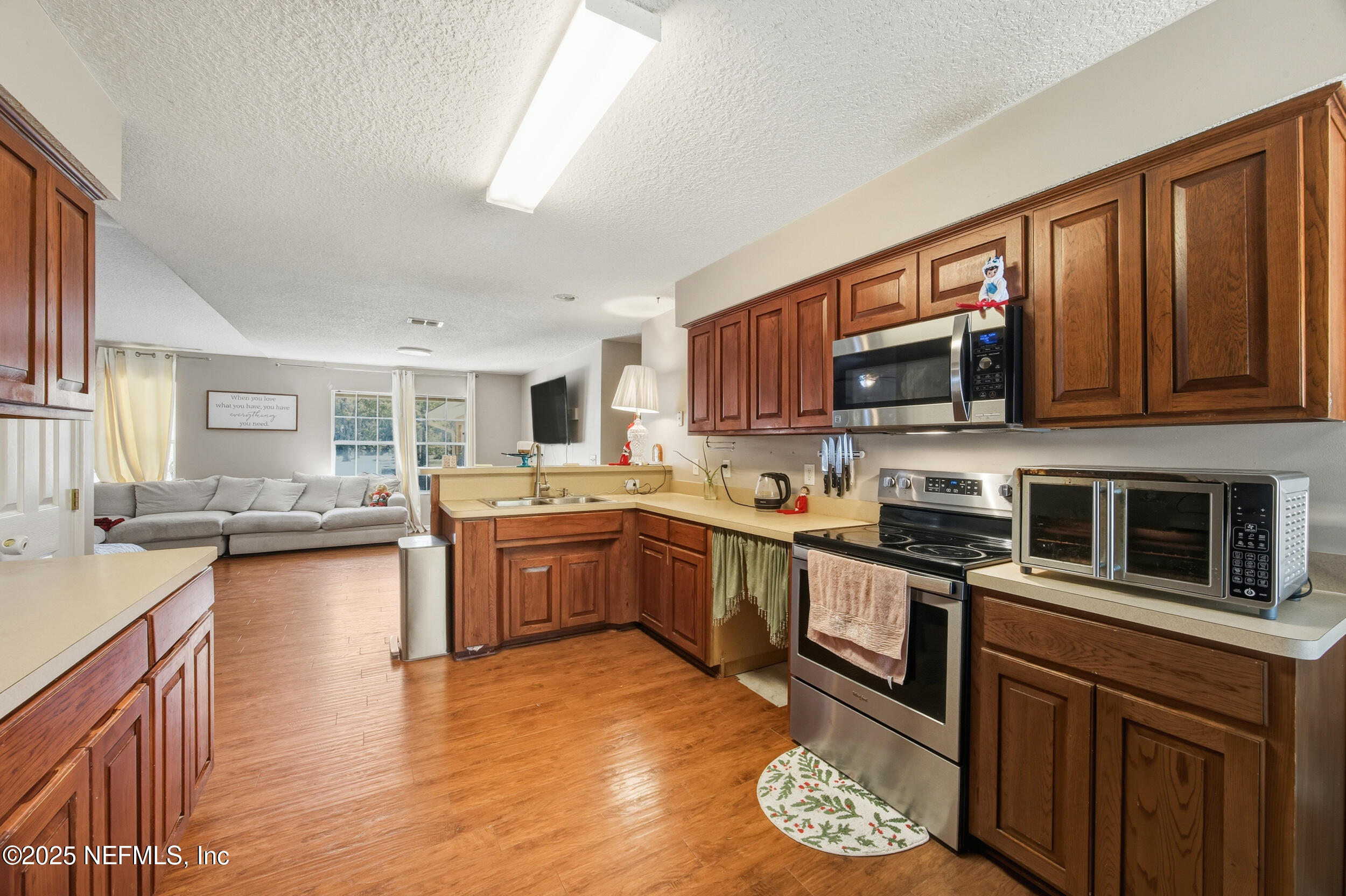 5720 Younis Road South Jacksonville, FL 32218 - Photo 19 of 34 a kitchen with stainless steel appliances granite countertop a stove sink microwave and cabinets