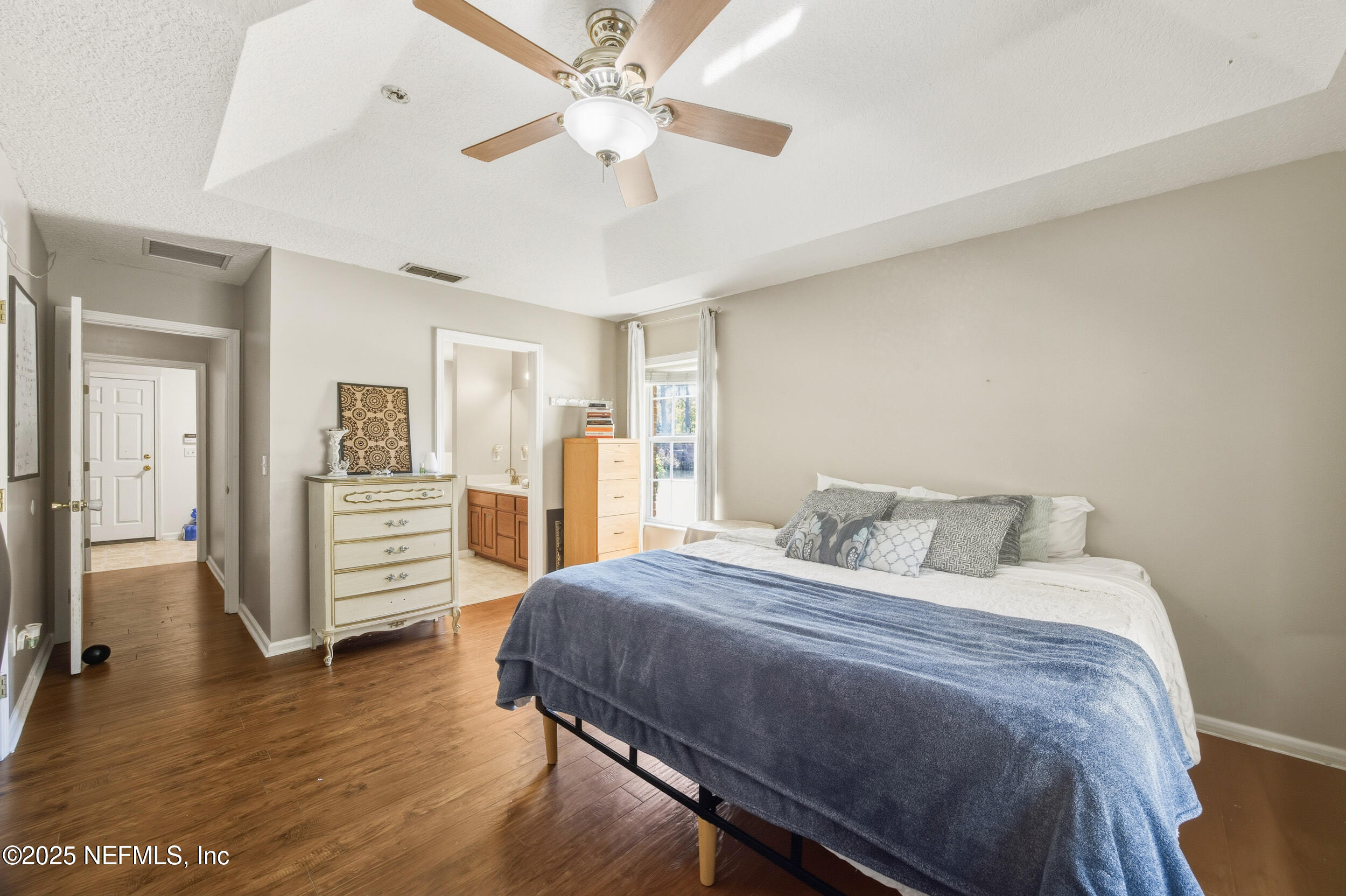 5720 Younis Road South Jacksonville, FL 32218 - Photo 32 of 34 a bedroom with a bed and a chandelier