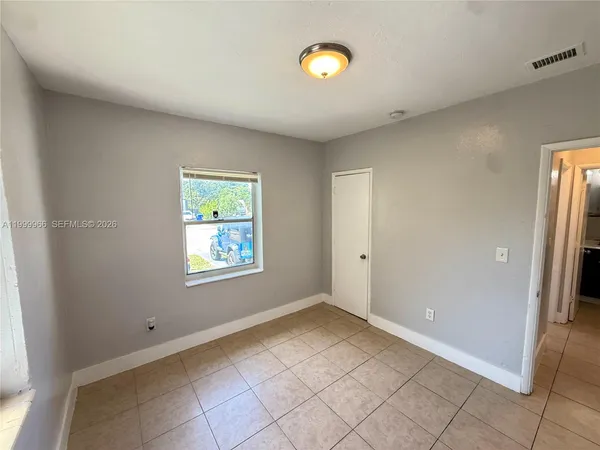 a view of an empty room with a window