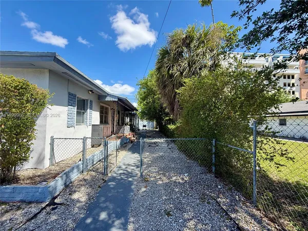 a view of a house with backyard and sitting area