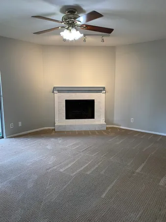 a view of an empty room with a fireplace