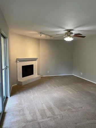 a view of empty room with fireplace