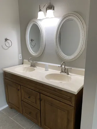 a bathroom with a sink double vanity and a mirror