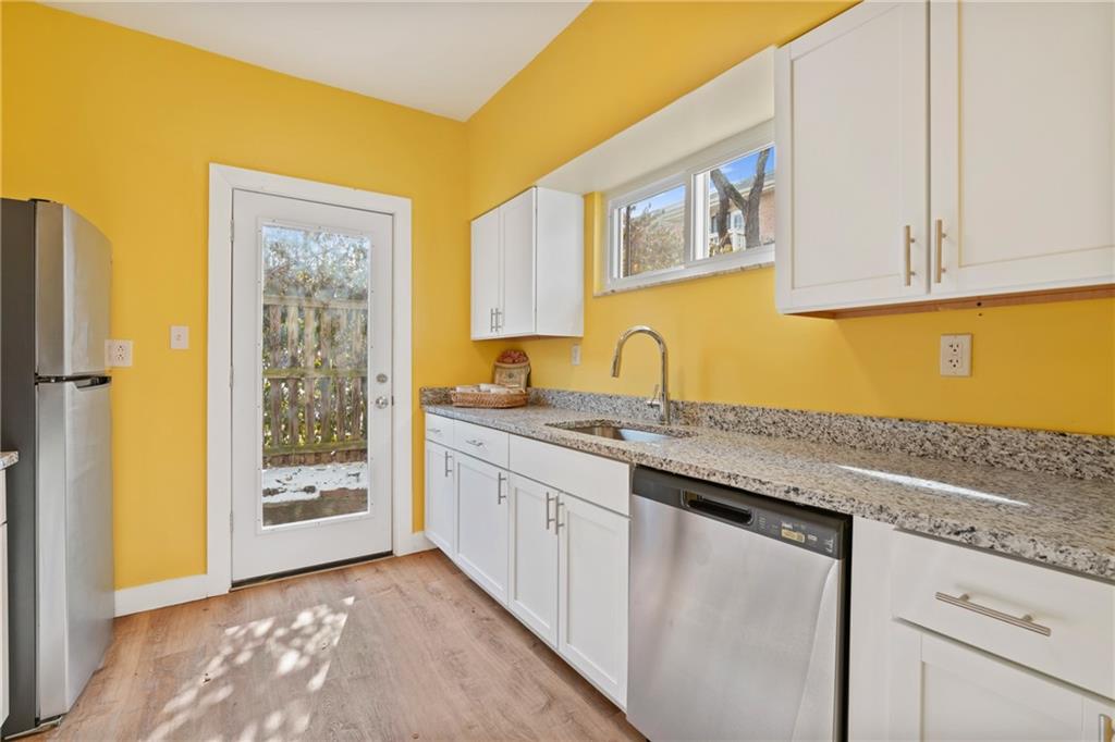 9 Edith Place Pittsburgh, PA 15213 - Photo 11 of 25 a kitchen with stainless steel appliances granite countertop a sink and cabinets with wooden floor