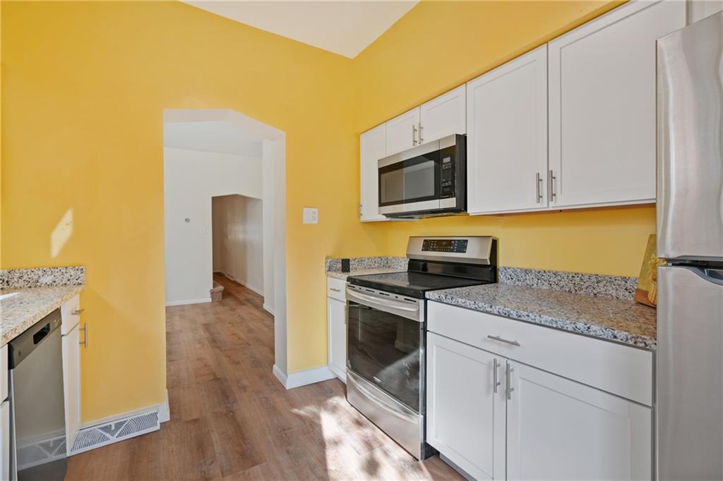 9 Edith Place Pittsburgh, PA 15213 - Photo 13 of 25 a kitchen with stainless steel appliances granite countertop a stove a sink and a microwave