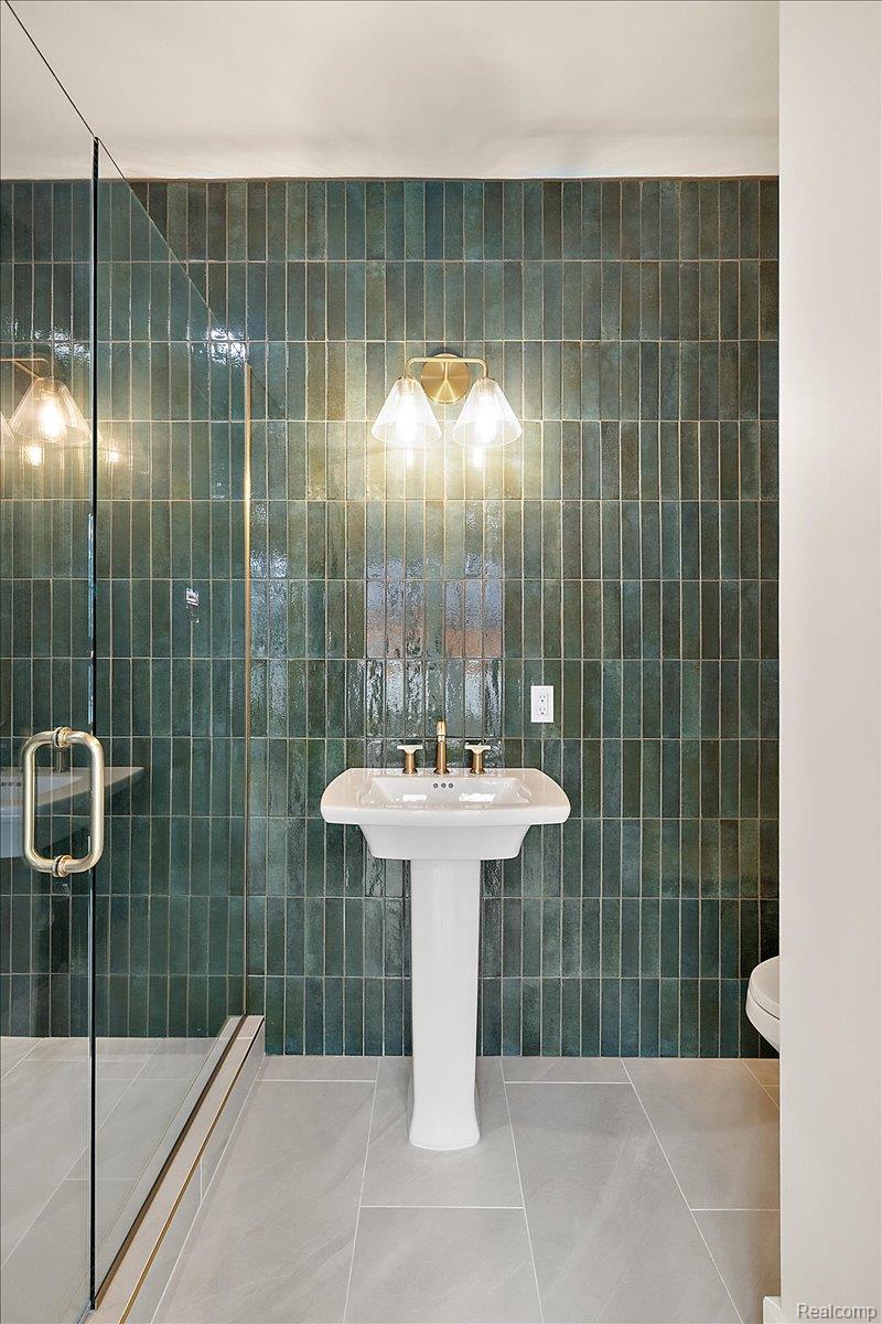 13459 Haddon Street Fenton, MI 48430 - Photo 25 of 84 Full bath with tile patterned floors, a stall shower, and tile walls