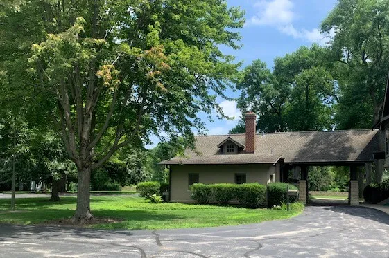a front view of a house with a garden
