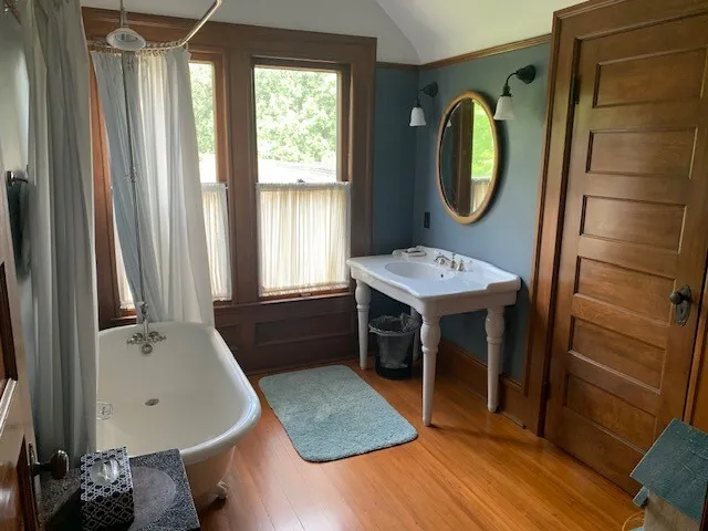 a bathroom with a sink a mirror and a bathtub