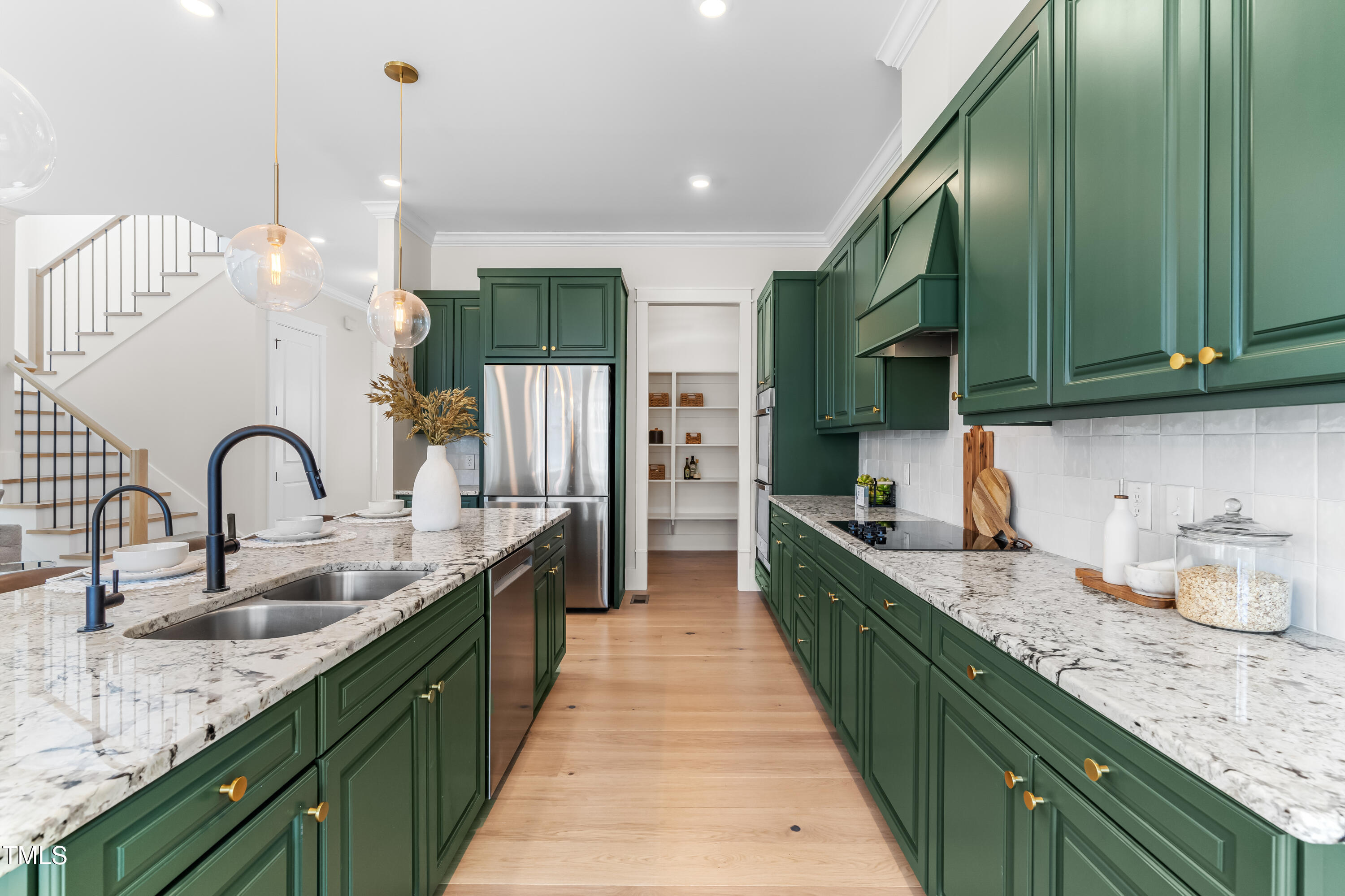 409 Tintern Lane Apex, NC 27523 - Photo 12 of 62 a large kitchen with kitchen island a sink and wooden cabinets