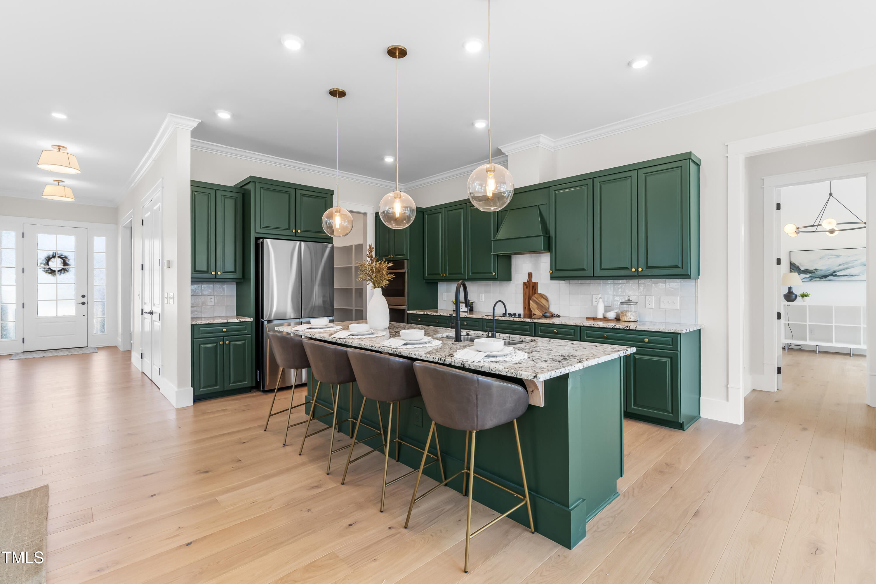 409 Tintern Lane Apex, NC 27523 - Photo 14 of 62 a kitchen with kitchen island granite countertop a sink and a stove top oven