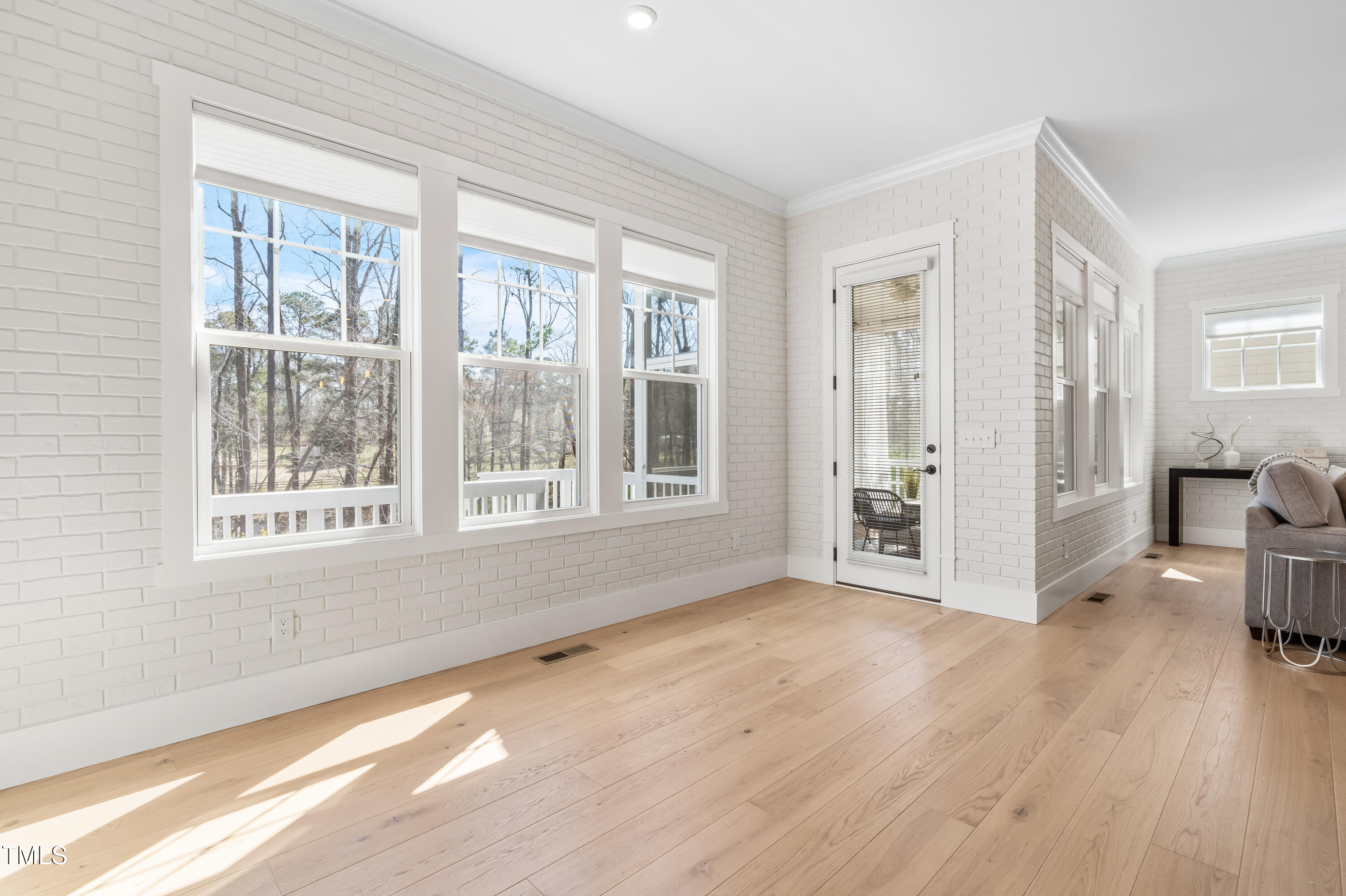 409 Tintern Lane Apex, NC 27523 - Photo 15 of 62 a view of an empty room with wooden floor and a window