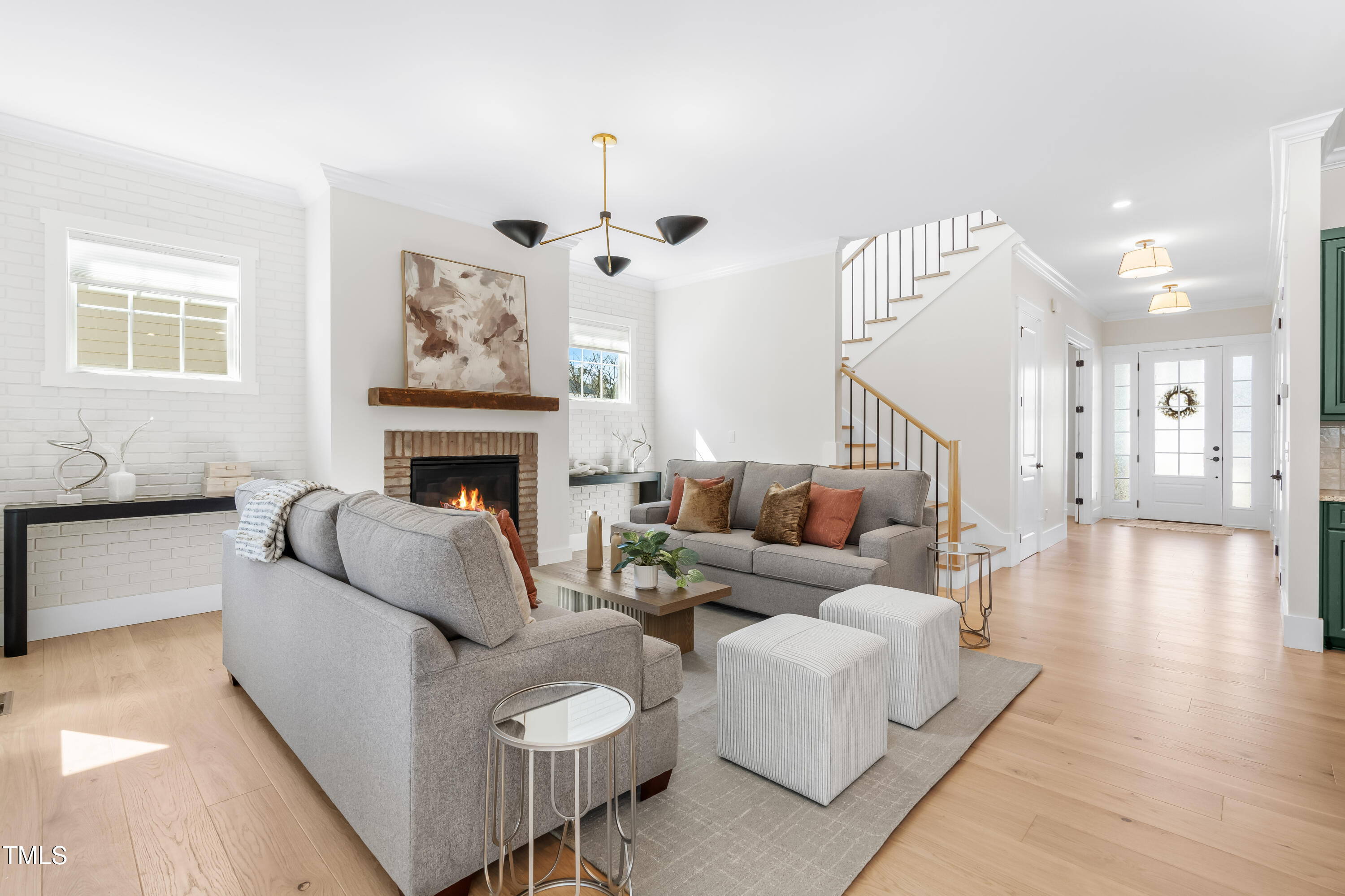 409 Tintern Lane Apex, NC 27523 - Photo 16 of 62 a living room with furniture and a fireplace